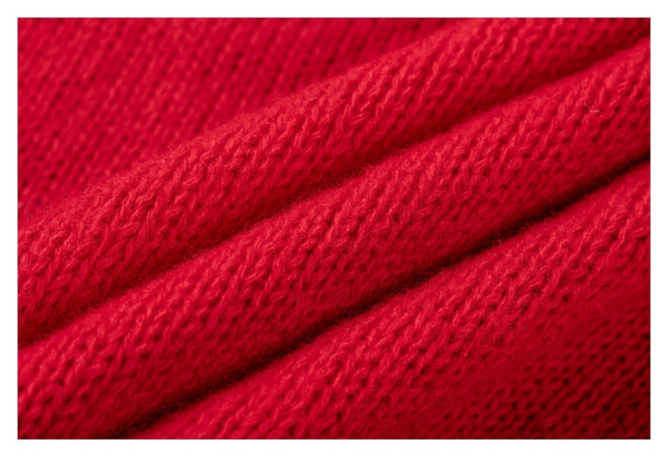 Macro view of the red knit fabric's textured stitches.