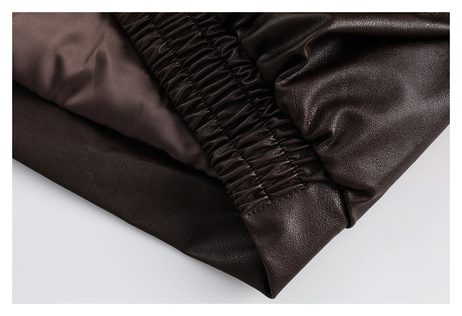 Close-up of the dark brown garment's gathered elastic cuff and smooth inner lining.