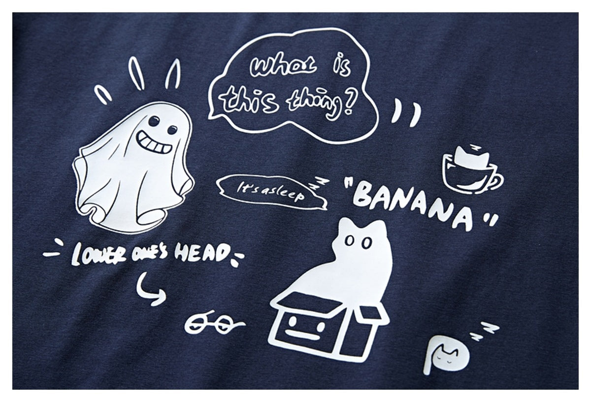 Close-up of a navy garment with white cartoon drawings and playful English text printed on it.