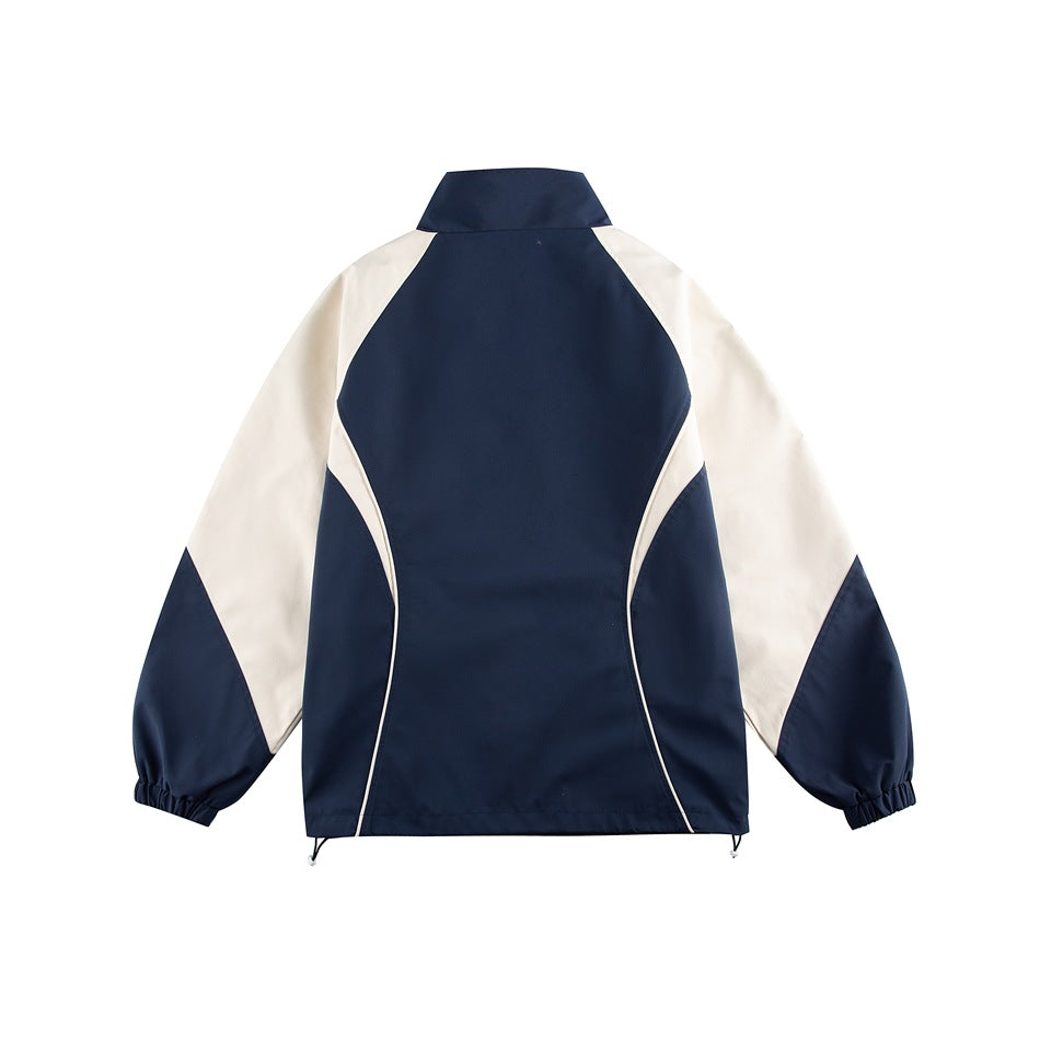 Back view of navy jacket with cream raglan sleeves, curved cream piping, elastic cuffs and hem drawcord toggles