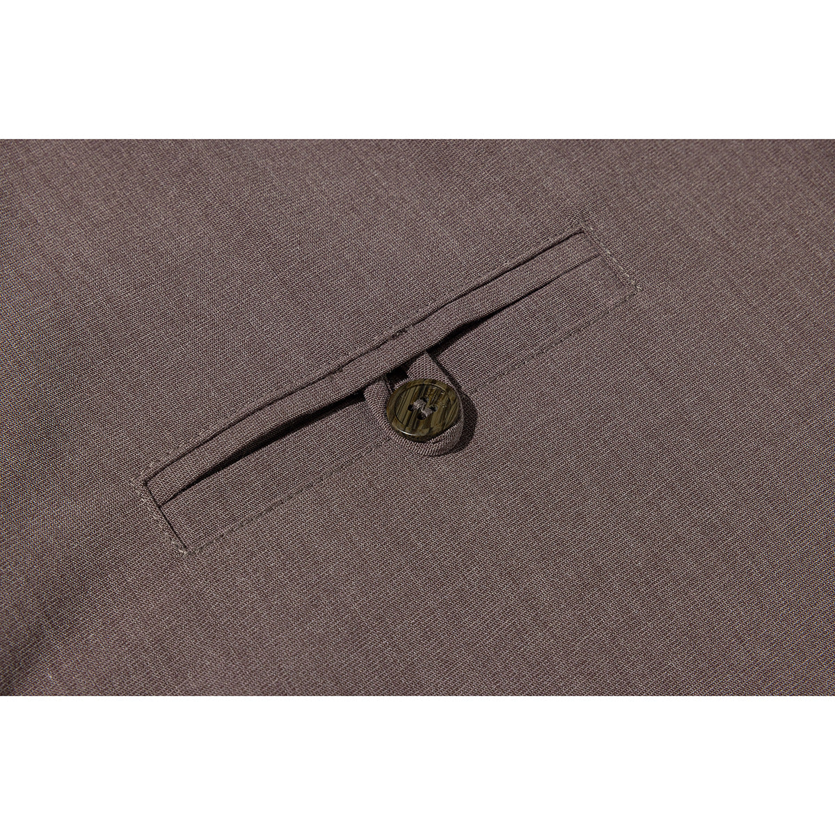 Close-up of a brown shirt's welt pocket and single button.