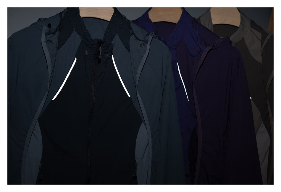 Front view of three hooded jackets in dark teal, purple and taupe displayed on hangers.