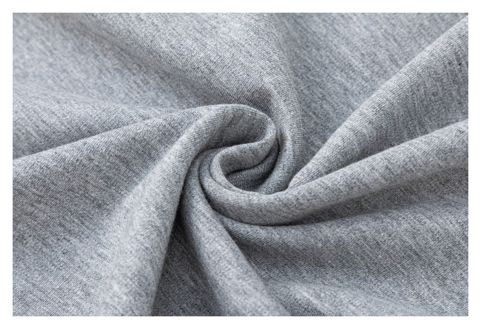 Close-up of heather gray knit fabric gathered into folds, showing its surface texture.