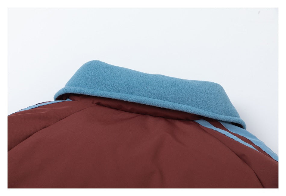Close-up of a burgundy garment with a light blue fleece-lined hood or collar and blue trim.