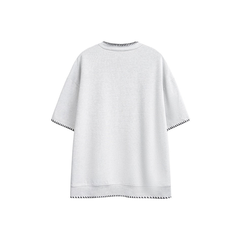 Back view of a light gray short-sleeve shirt with black contrast stitching at the collar, cuffs and hem.
