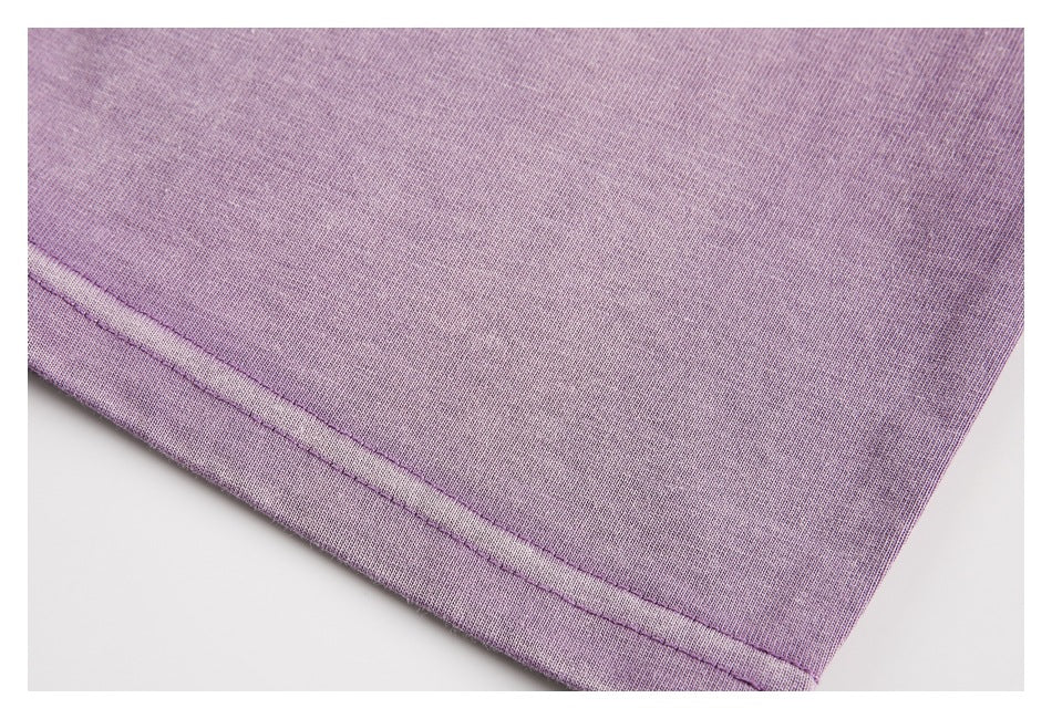 Close-up of the stitched hem on a lavender garment.