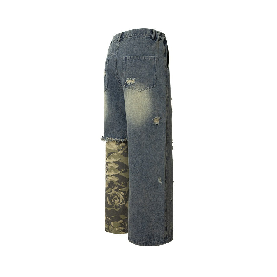 Rear three-quarter view of wide-leg faded blue jeans with distressed details and a camouflage-print lower-leg panel.