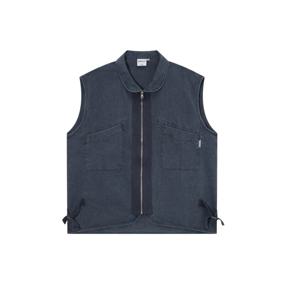 Faded blue sleeveless vest shown from the front, with a rounded collar, full-length zipper, two chest pockets, and side ties.