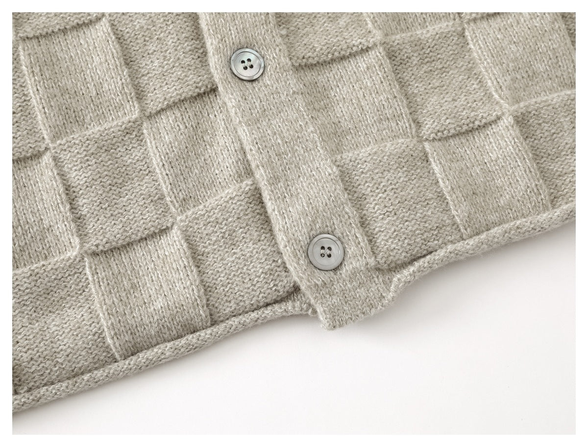 Close-up of the cardigan’s checkerboard knit, button placket, and finished lower hem.