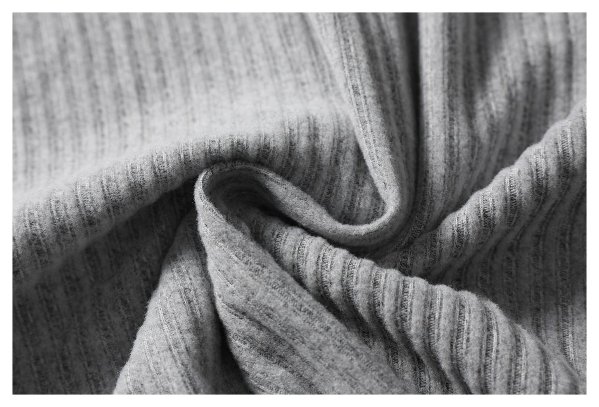 Close-up of heather-gray ribbed knit fabric folded into soft curves.
