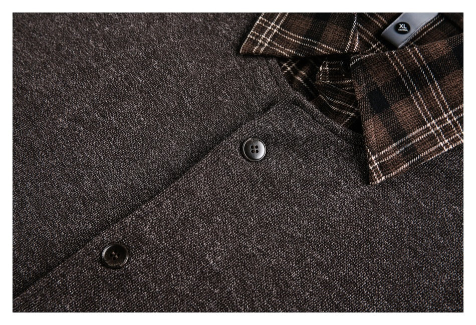 Close-up of dark buttons and textured charcoal fabric beside a brown plaid collar.