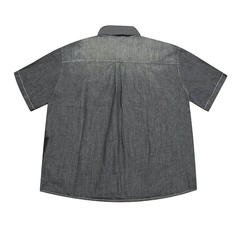 Back view of gray washed short-sleeve shirt with faded yoke, center pleat and white topstitching