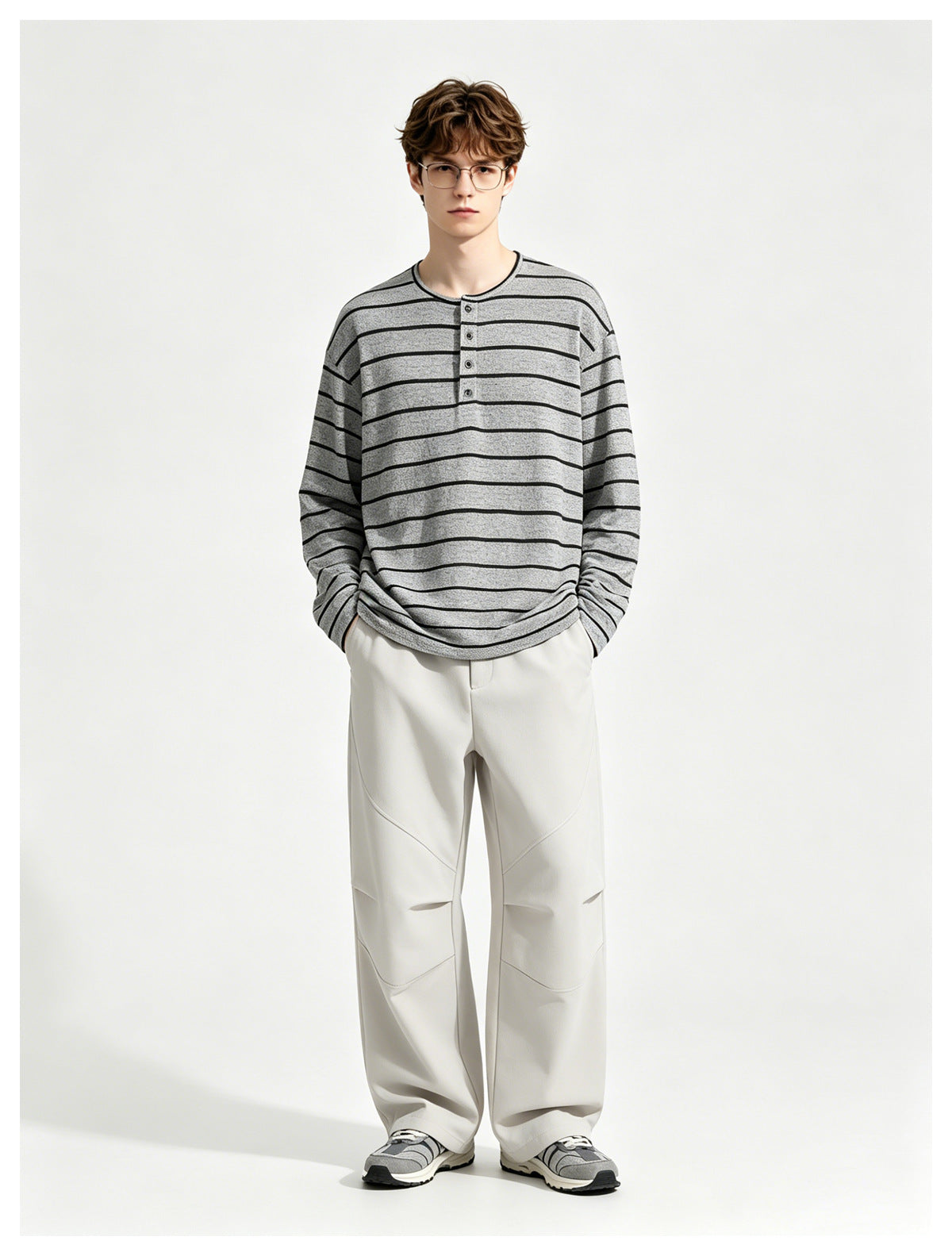 Model wearing the gray striped long-sleeve henley top with light gray wide-leg pants, front view