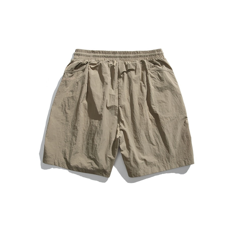 Back view of beige shorts with an elastic waistband and rear pocket.