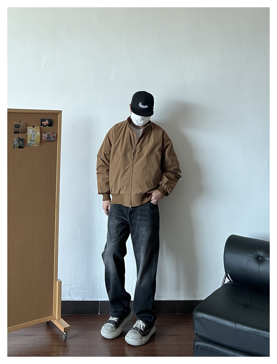 Full-length view of a person wearing the brown zip-front jacket with dark jeans and sneakers.