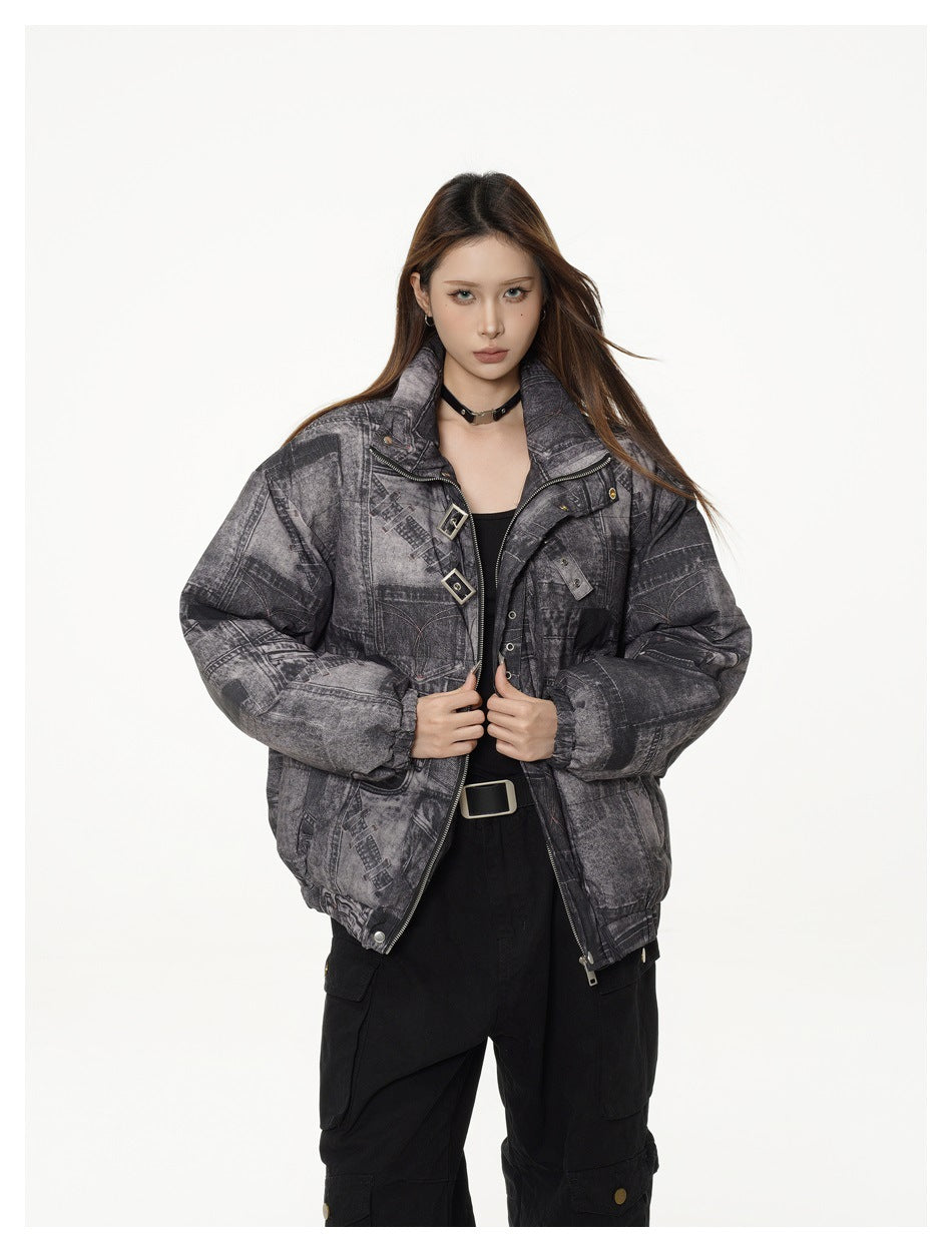 Woman wearing the denim-print jacket open at the front, showing zipper, buckle straps and black top