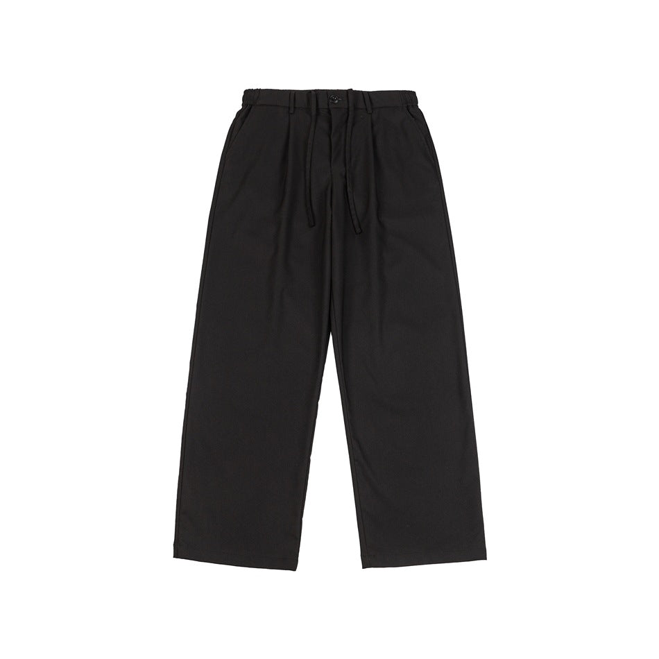 Black wide-leg trousers flat lay, front view with pleats, button, drawstring and side pockets