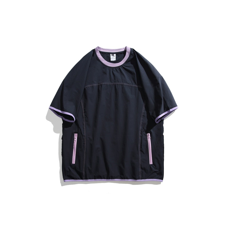 Navy short-sleeve crew neck top with lavender trim, lavender zippered side pockets and contrast stitching, flat lay