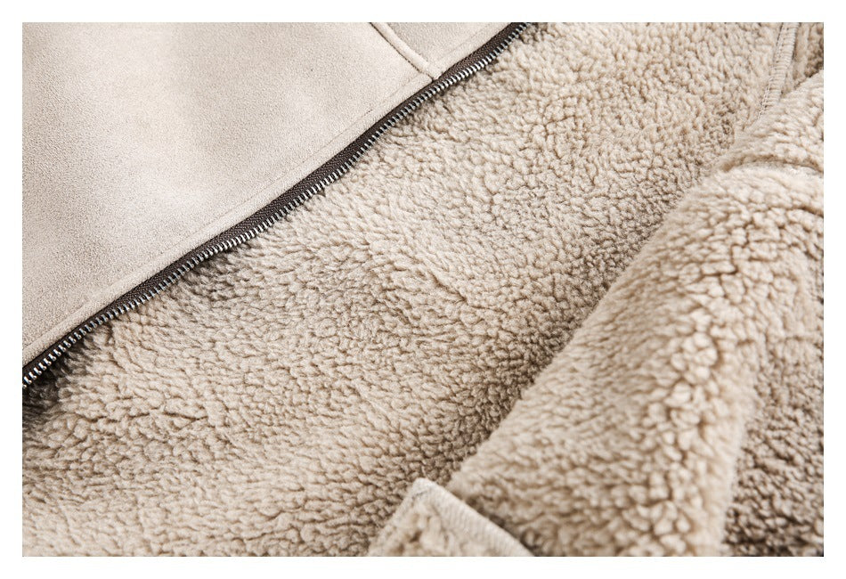 Close-up of a beige garment's dark zipper and plush, curly-textured lining.