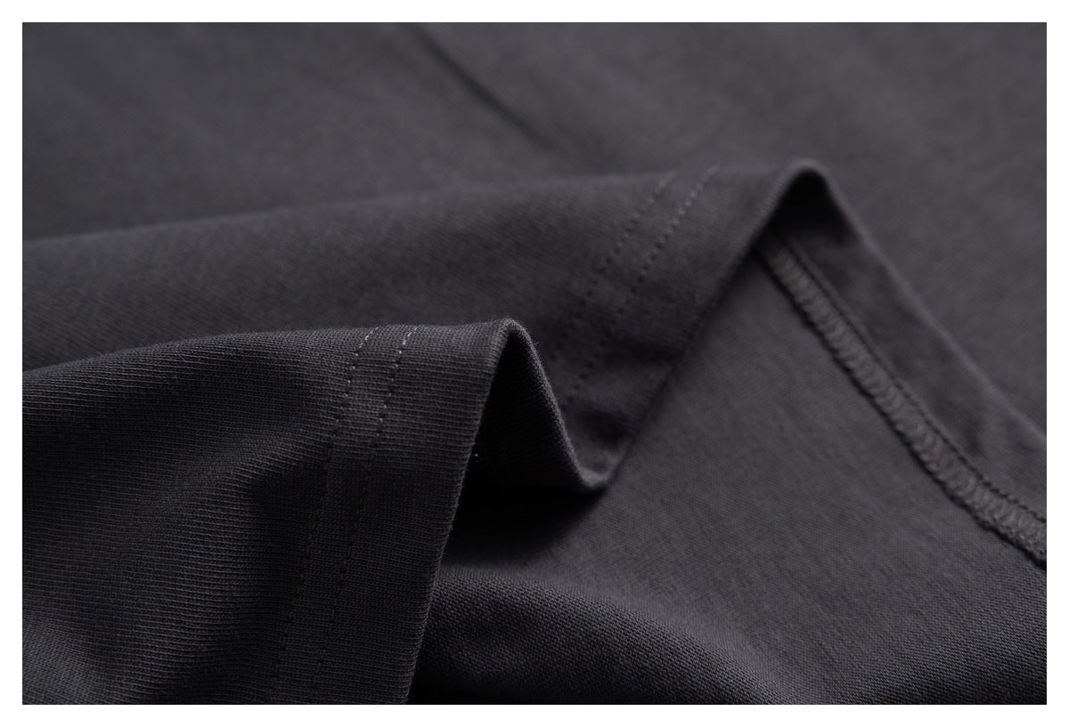 Close-up of a charcoal T-shirt sleeve edge and interior stitching.