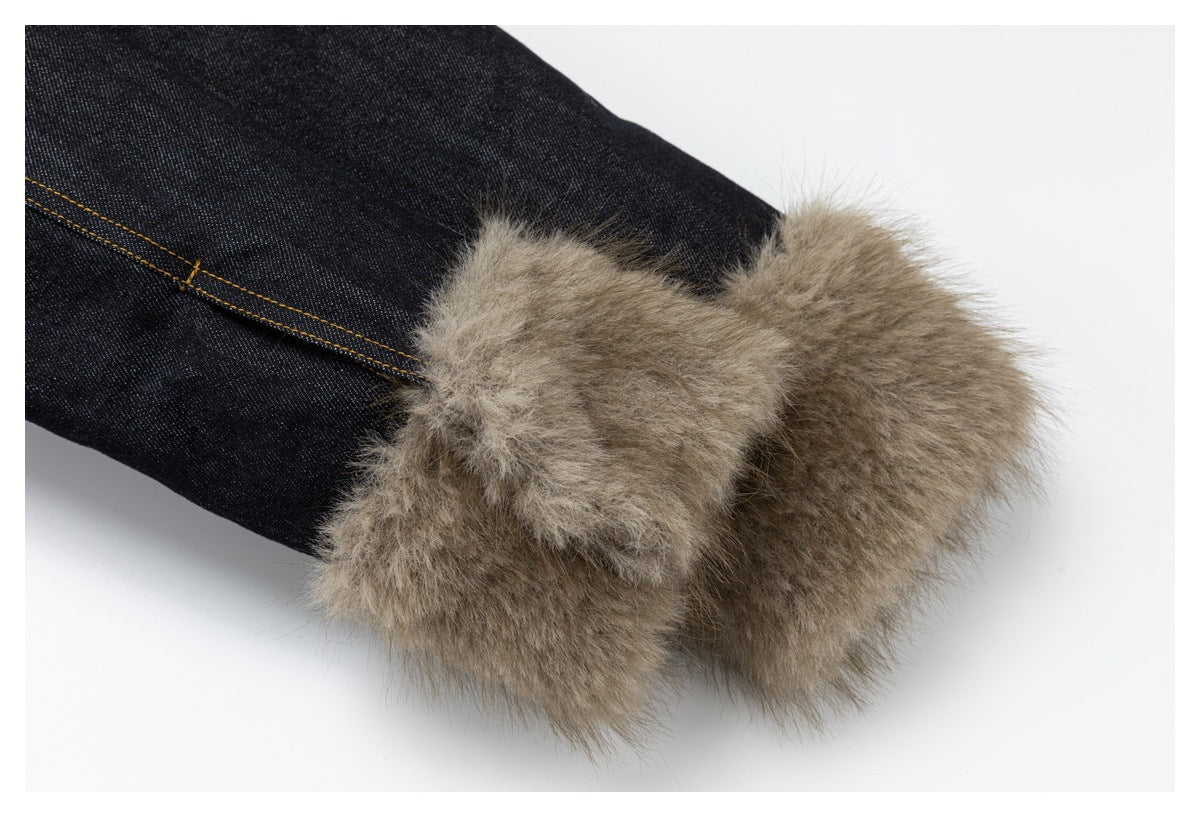 Close-up of a denim sleeve cuff finished with wide taupe fluffy trim.
