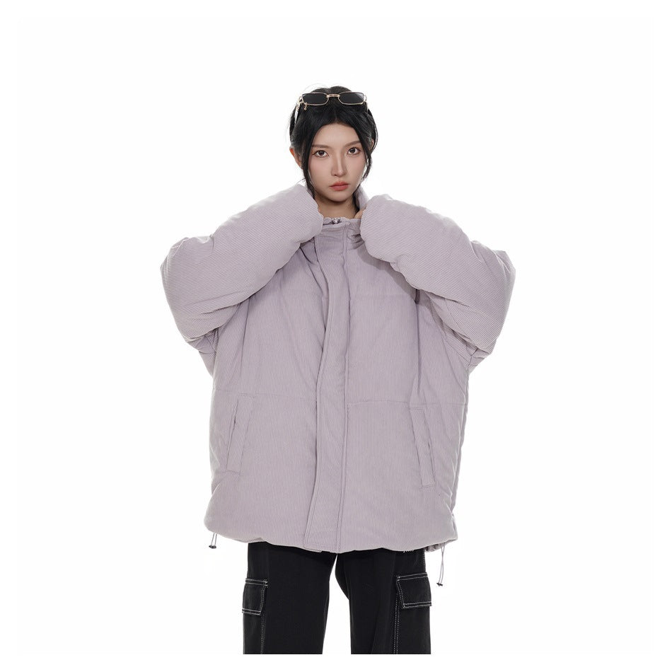 Model wearing an oversized light purple ribbed puffer jacket with raised sleeves and black cargo pants