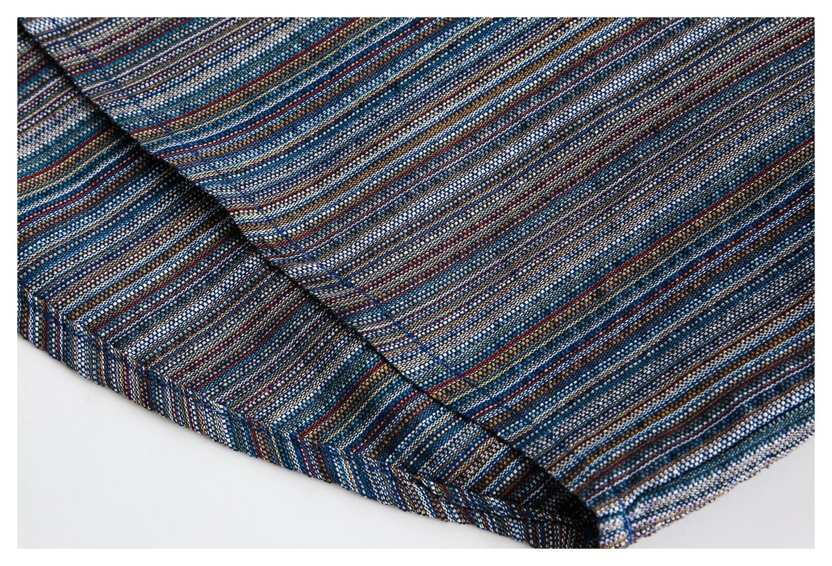 Close-up of the stitched folded edge of a garment with fine blue, white, rust, and tan stripes.