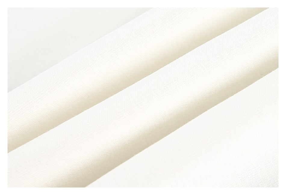 Close-up of folded white fabric showing its surface and edge.