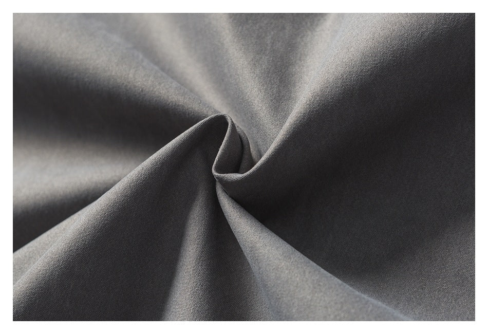 Close-up of gray jacket fabric gathered into soft folds.