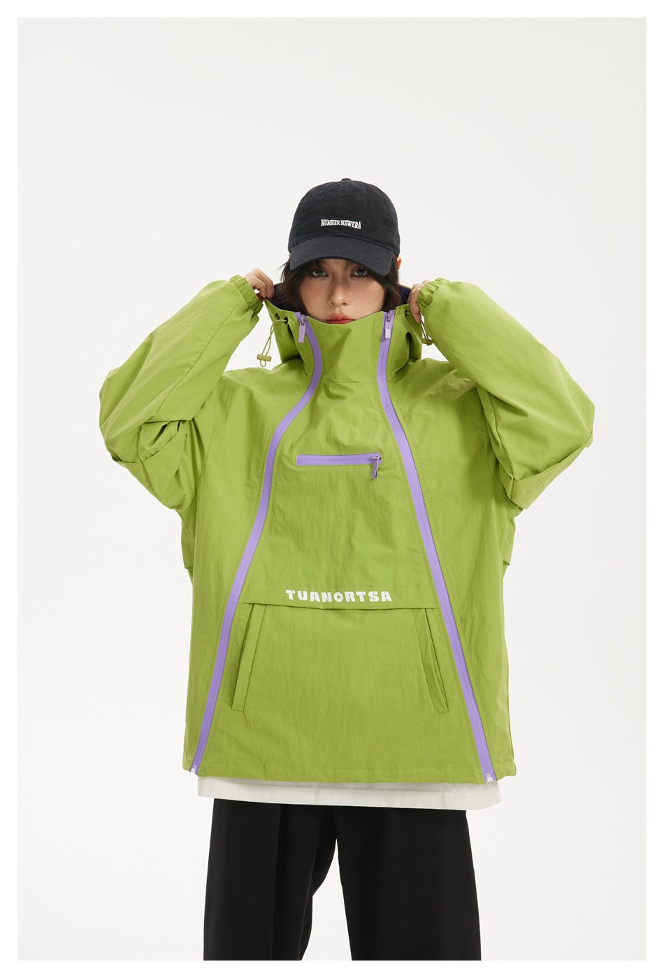 Front view of a model wearing a lime green hooded jacket with lavender zippers and a large front pocket.