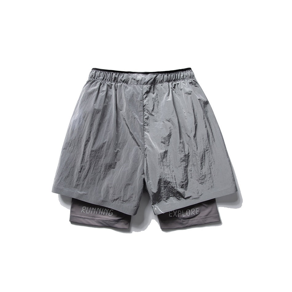 Back view of shiny silver-gray layered shorts with an elastic waistband and RUNNING and EXPLORE lettering on the inner
