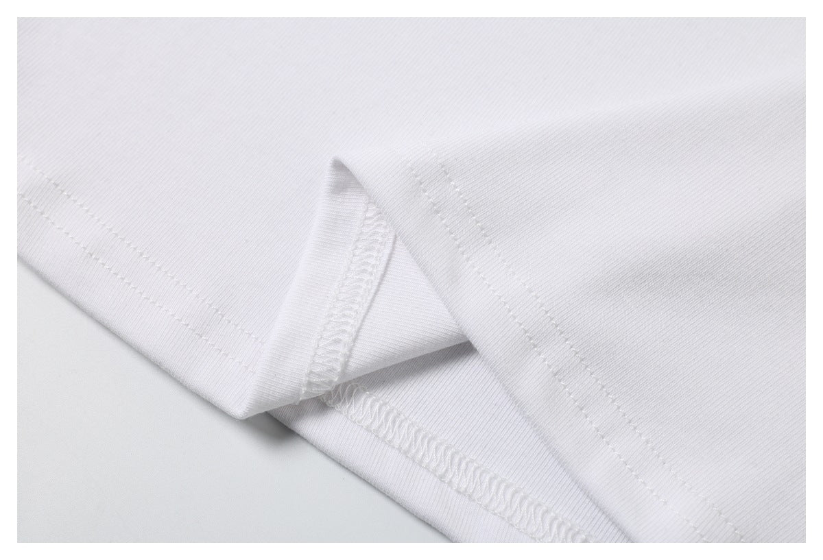 Close-up of the white T-shirt’s folded lower hem and interior stitching.