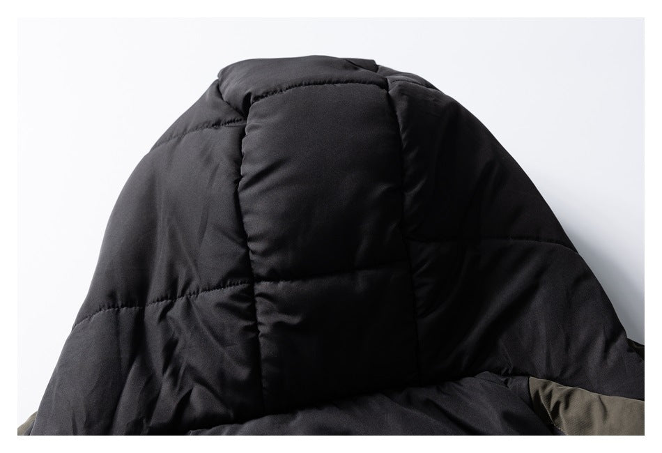 Close-up of black quilted padding inside an olive jacket hood.