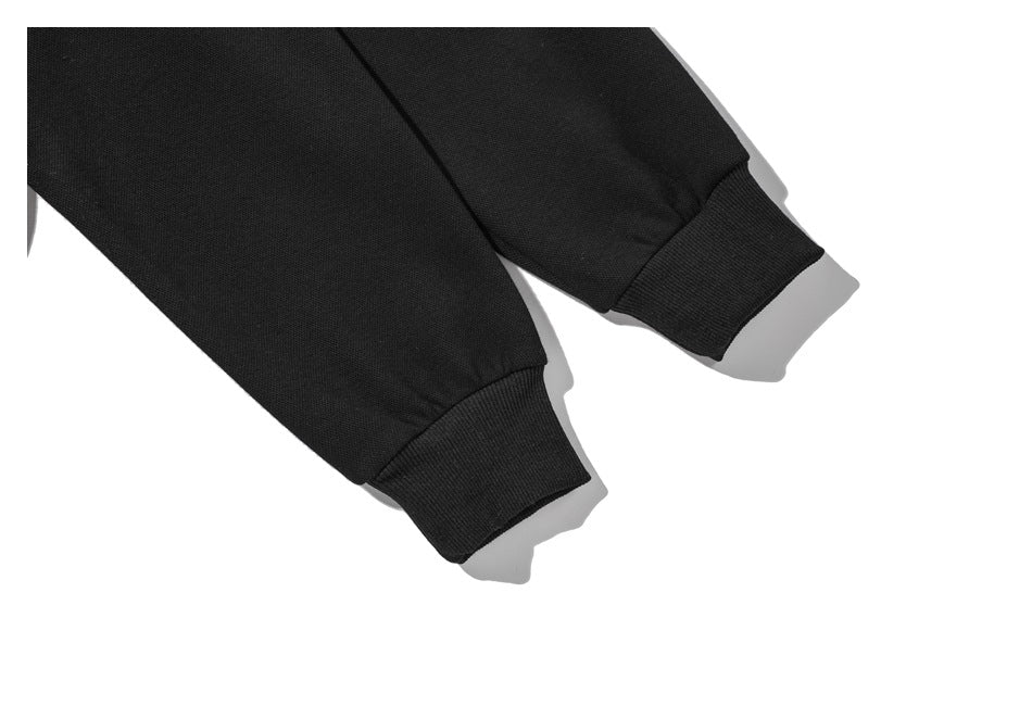 Close-up of two black sleeves with ribbed cuffs against a white background.