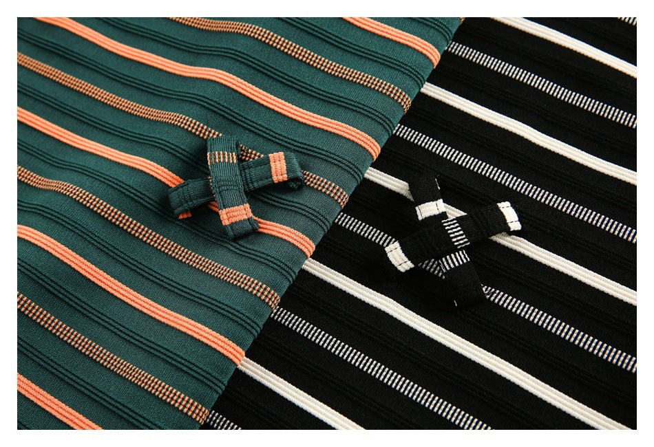 Close-up of small bow details on green-and-orange and black-and-white striped tops.
