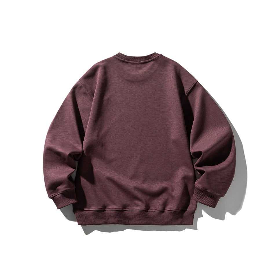 Back view of a plum-colored crewneck sweatshirt with a relaxed fit and ribbed cuffs and hem.