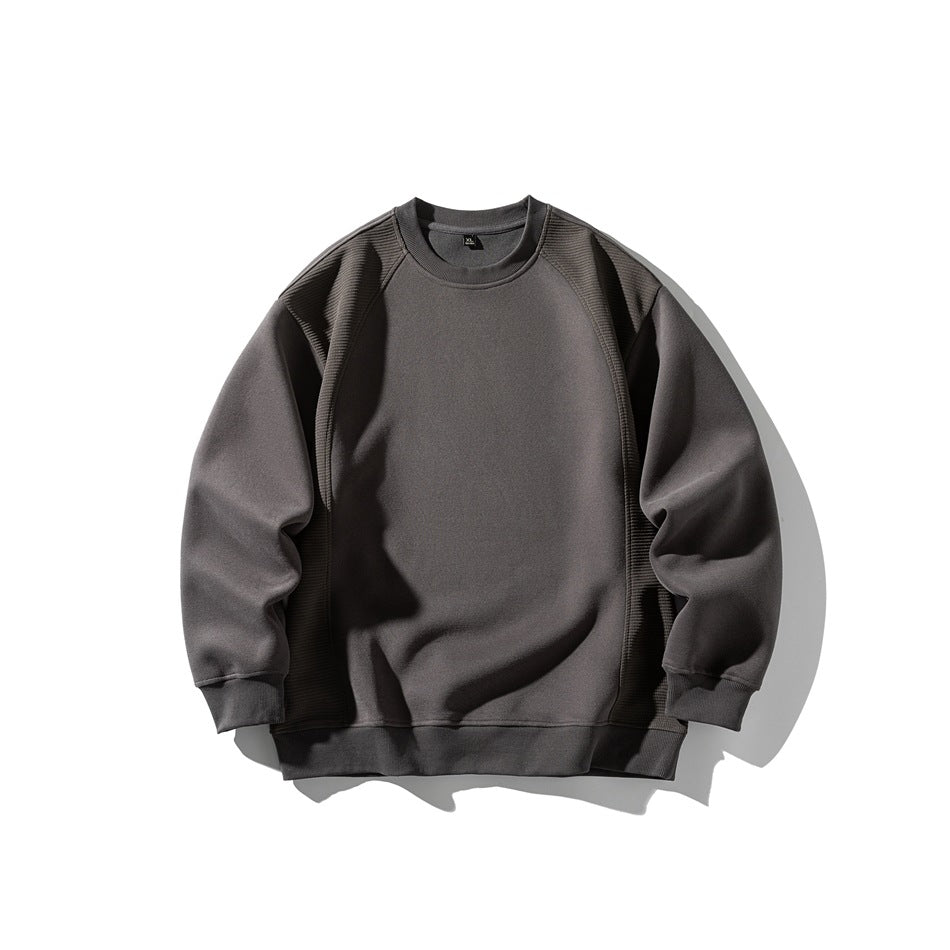 Charcoal gray crewneck sweatshirt with ribbed raglan panels and ribbed cuffs and hem, flat lay front view