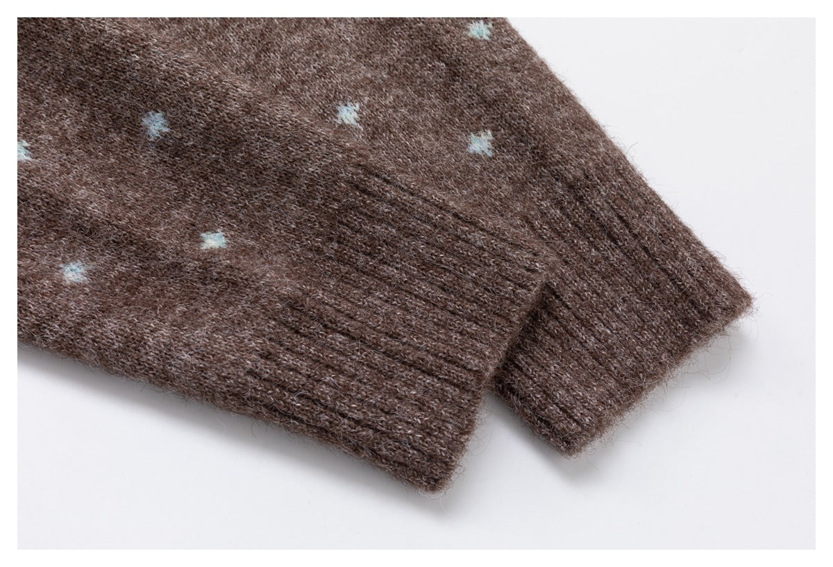 Close-up of a brown knit garment's ribbed cuff beside its pale blue dotted pattern.