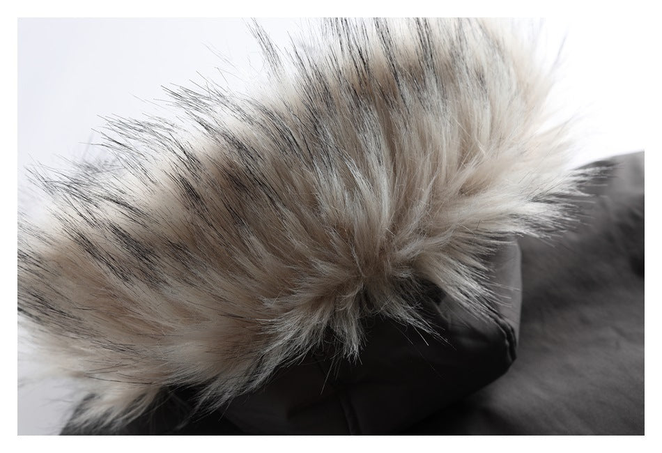 Close-up of a black hood edged with long gray and cream faux fur.
