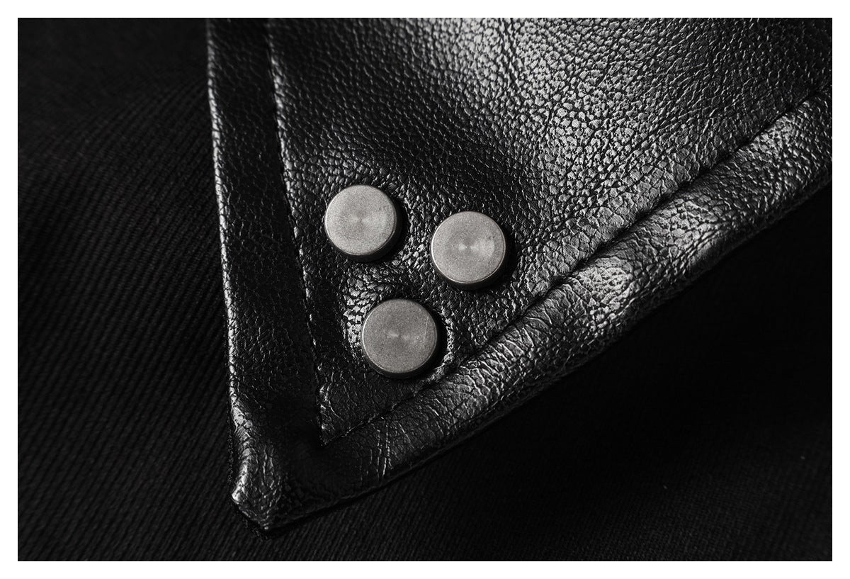 Close-up of a black textured lapel with three round silver snaps.