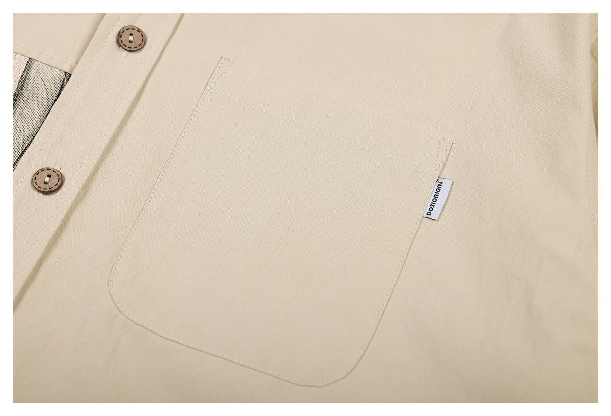 Close-up of a beige shirt's large patch pocket, button placket, and small sewn tag.
