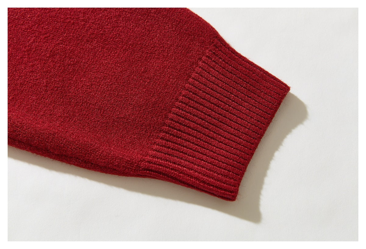 Close-up of a plain red sweater sleeve ending in a wide ribbed cuff.