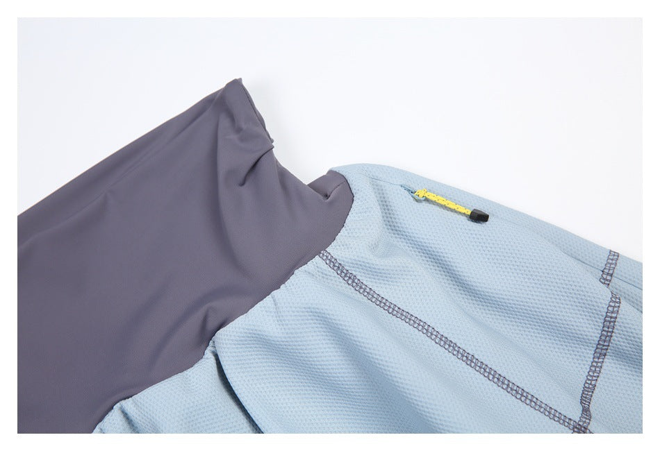 Close-up showing the slate-gray waistband, light blue textured fabric, seam stitching, and yellow zipper pull.
