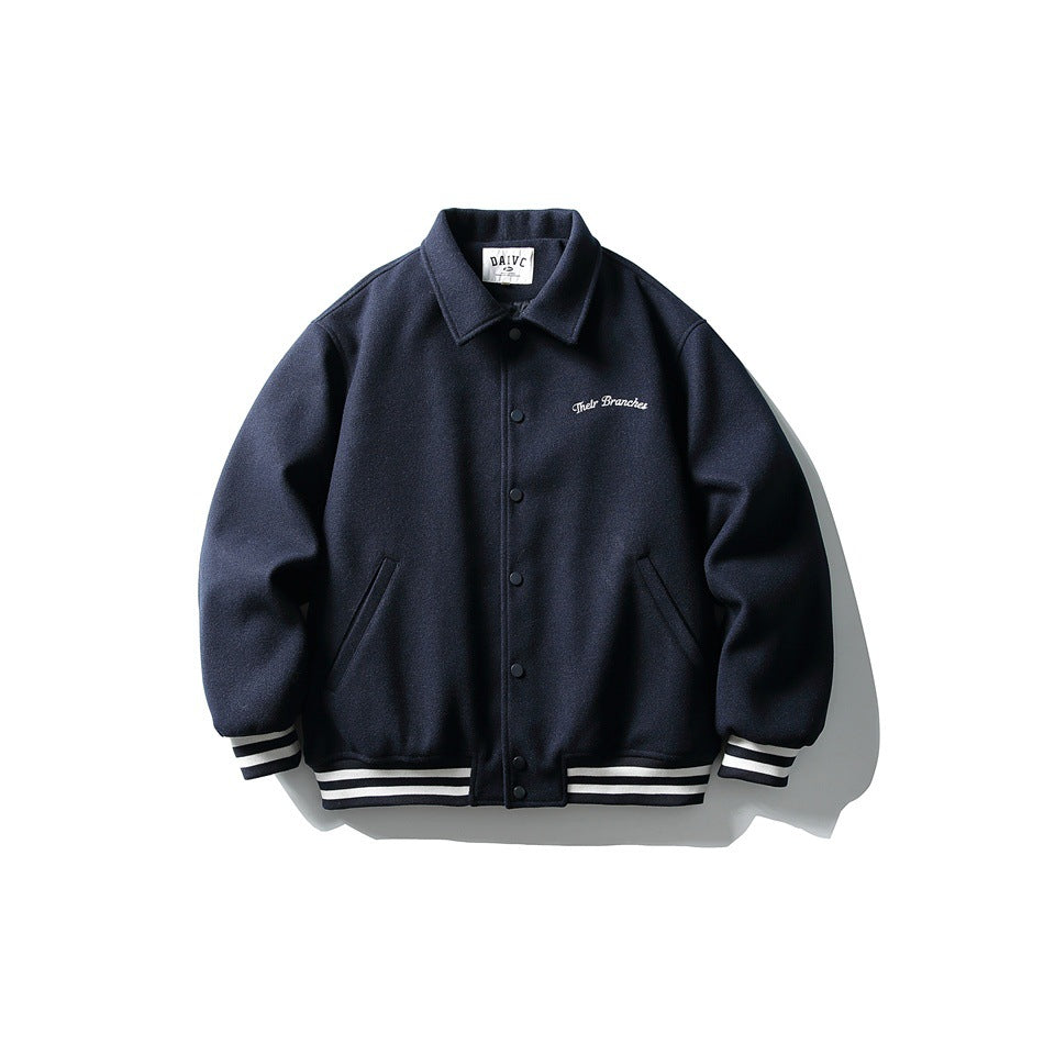 Navy varsity-style jacket with collar, snap buttons, striped cuffs and hem, and white script embroidery on the chest