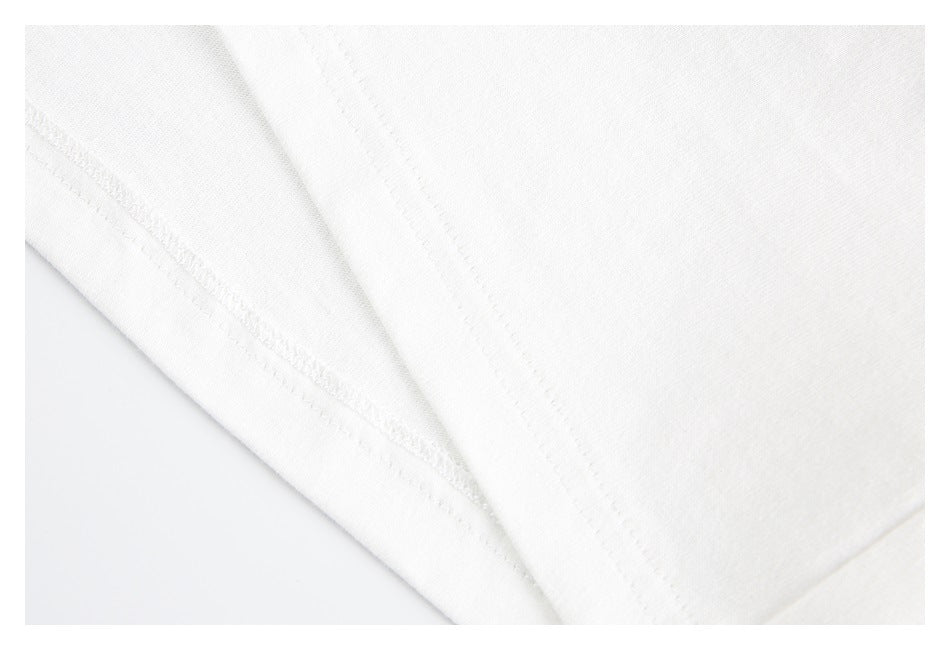 Close-up of the white T-shirt's fabric and stitched seam.