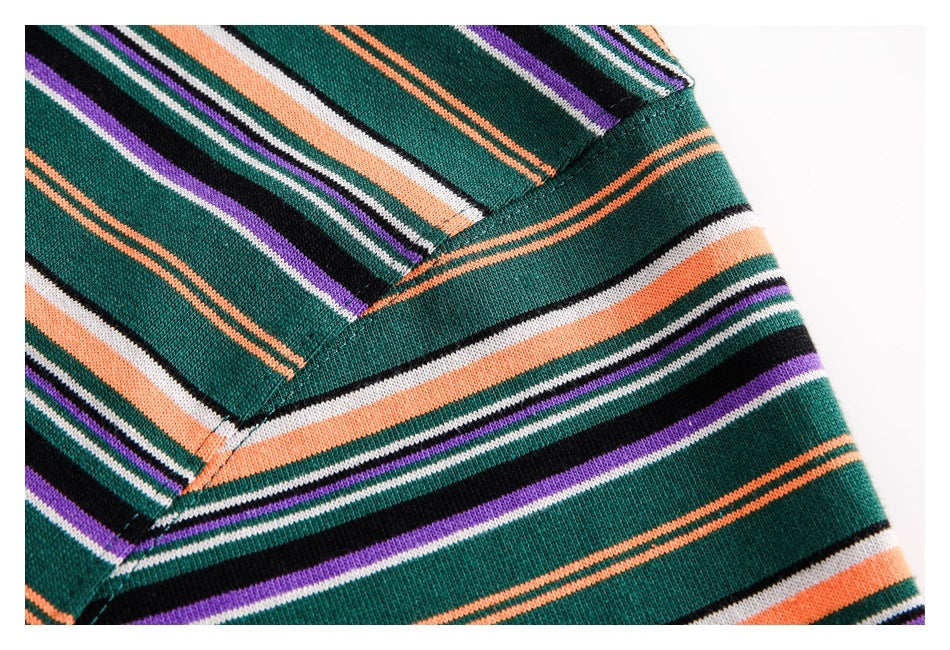 Close-up of the striped knit top's shoulder and sleeve seam.