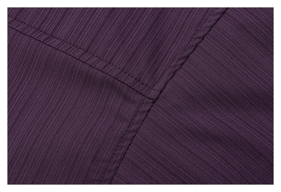 Close-up of dark plum ribbed fabric showing intersecting stitched seams.