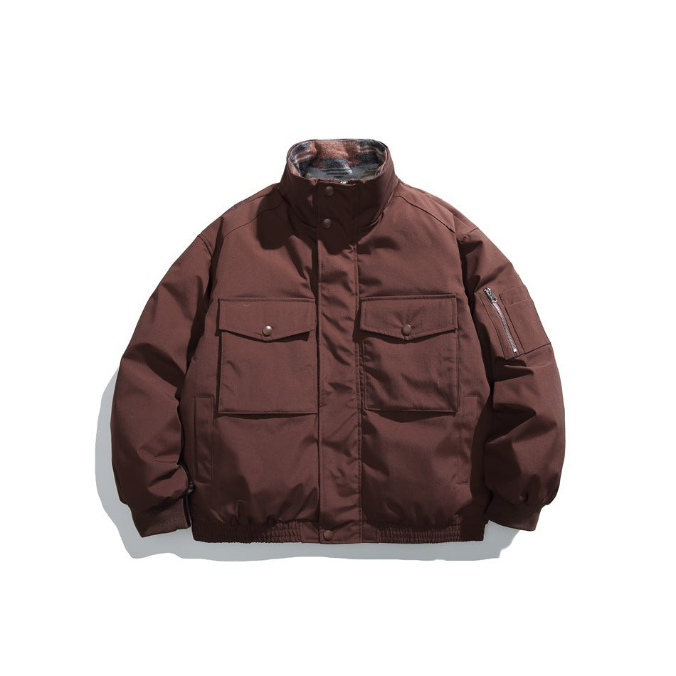 Front view of a burgundy jacket with a high stand collar, snap-flap chest pockets, a zippered sleeve pocket and gathered hem.