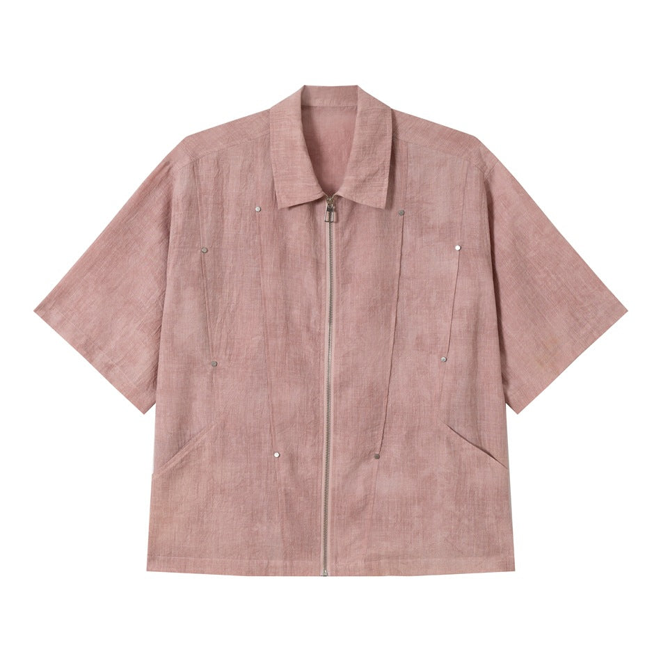 Dusty pink short-sleeve zip-front shirt with collar, metal studs and slanted pockets, front view on white