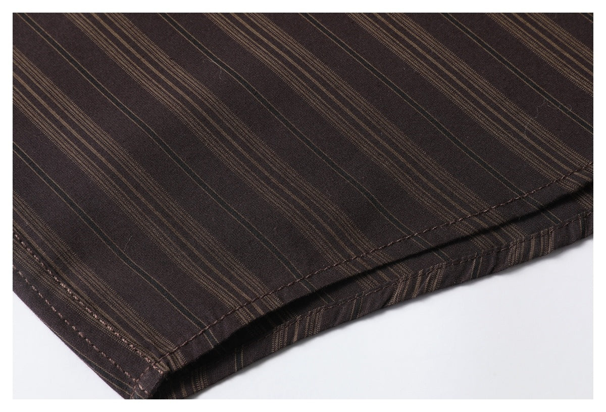 Close-up of a stitched hem on dark brown fabric with fine tan stripes.